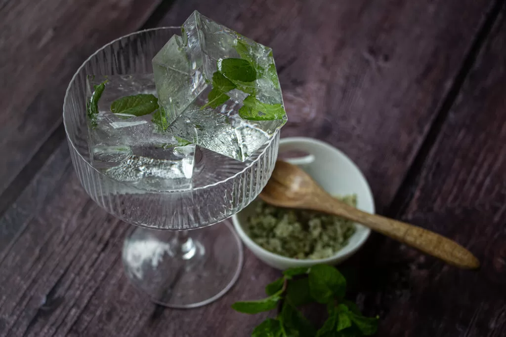 mint ice cubes in cocktail glass