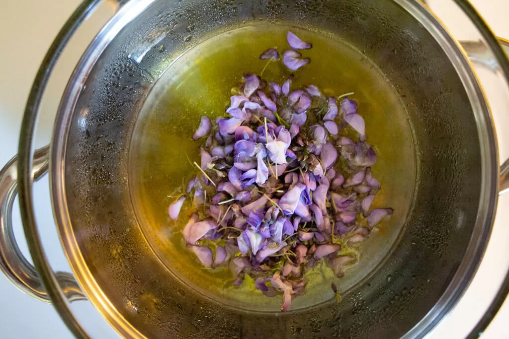 making wisteria infused oil in double boiler