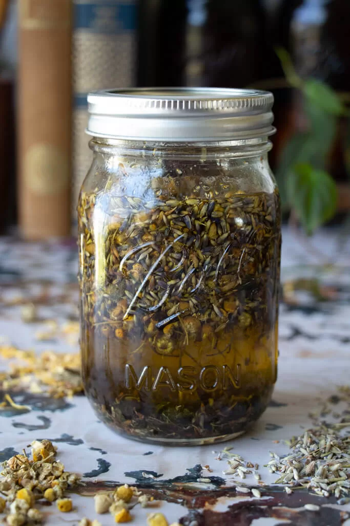 chamomile, calendula, and lavender infused olive oil in mason jar