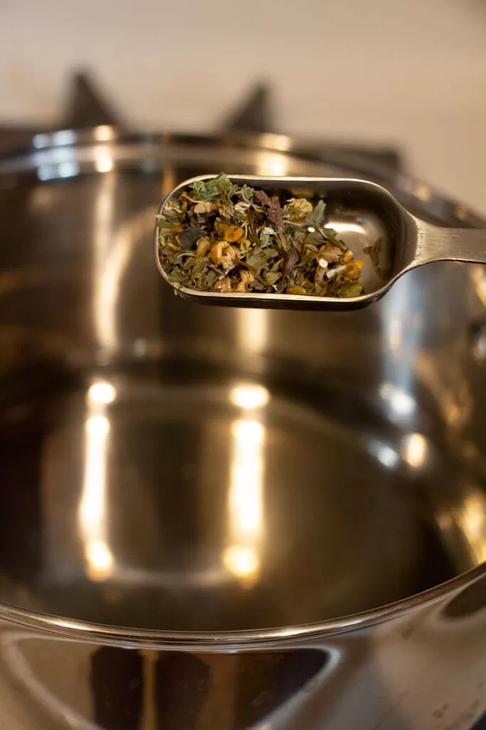 adding herbs to hot water