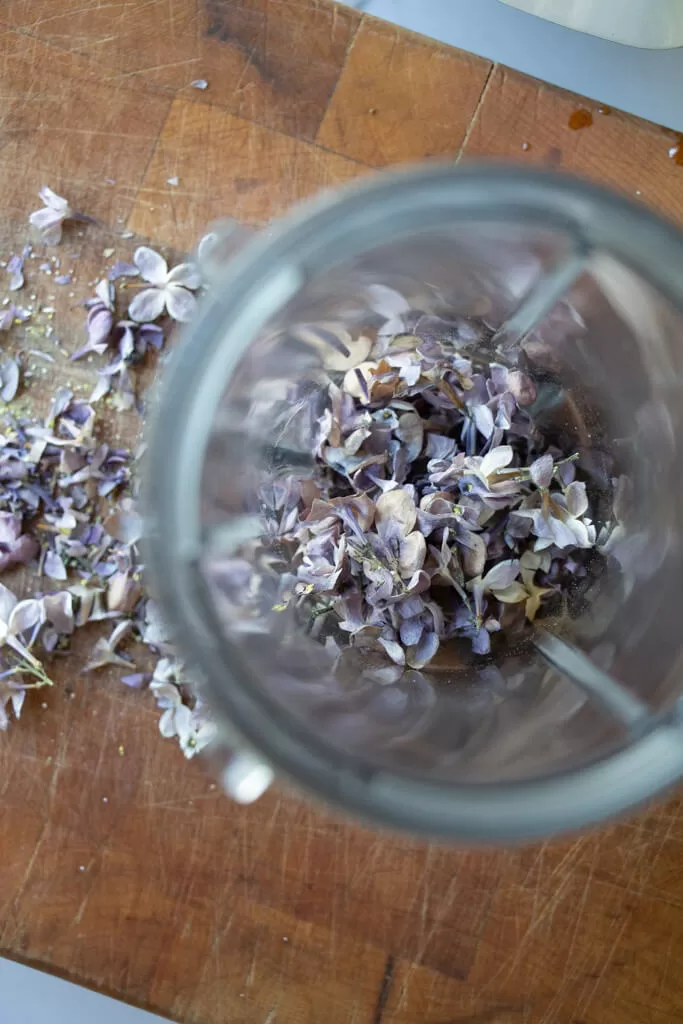 chopped lilacs in blender cup from above