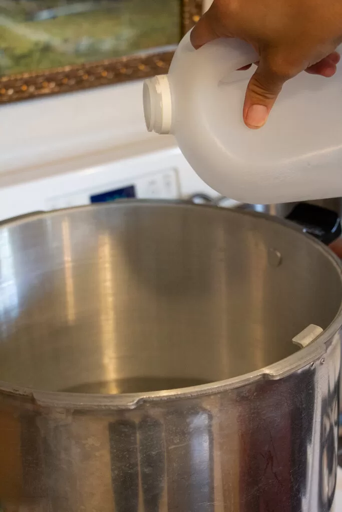 pouring vinegar into pot