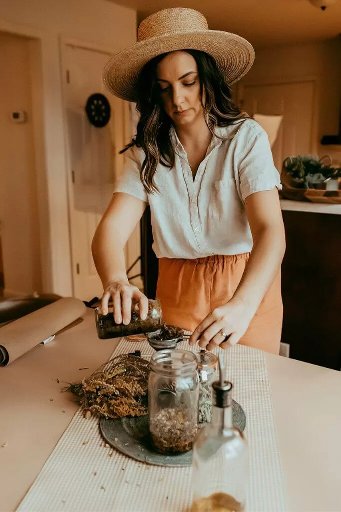 girl herb crafting making an herbal infused oil
