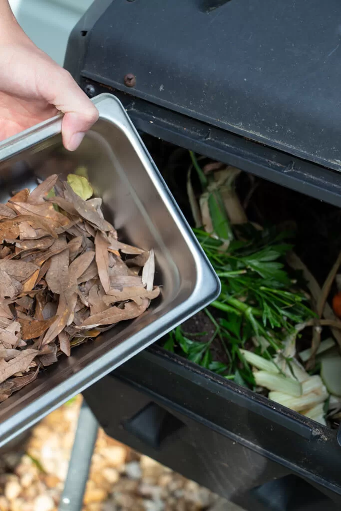 adding brown compost to bin