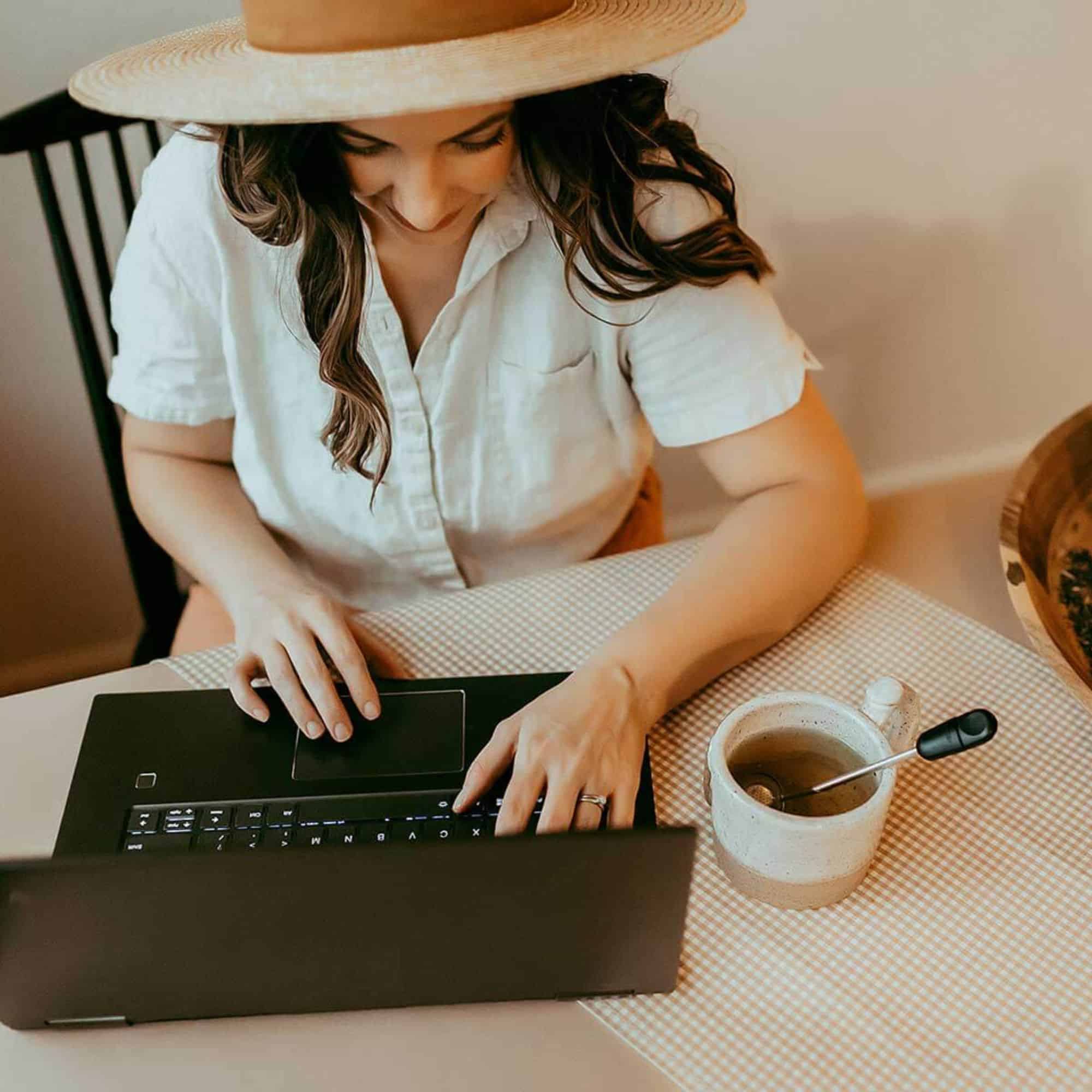 Brittany on her laptop in her facebook group with a coffee
