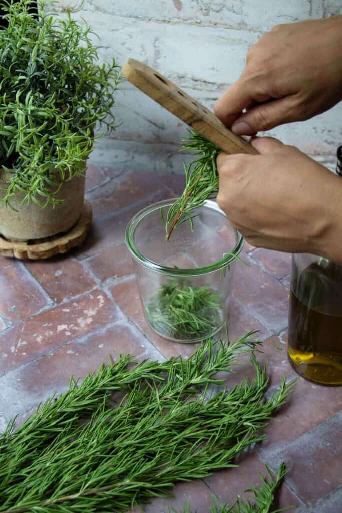 hand stripping rosemary with wood herb stripper