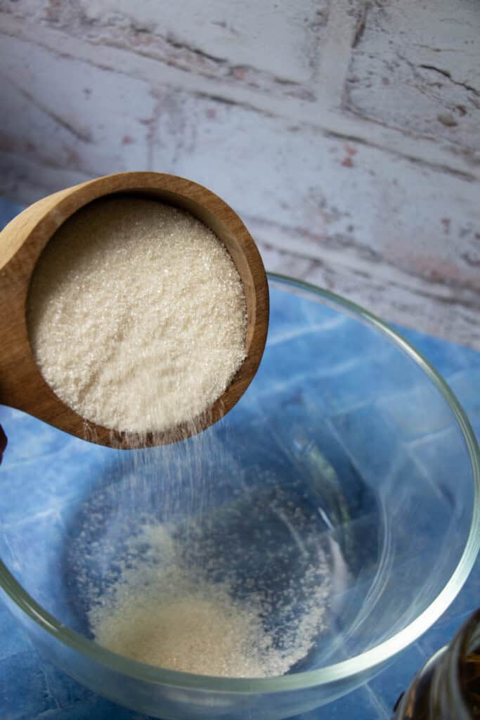 adding sugar to bowl