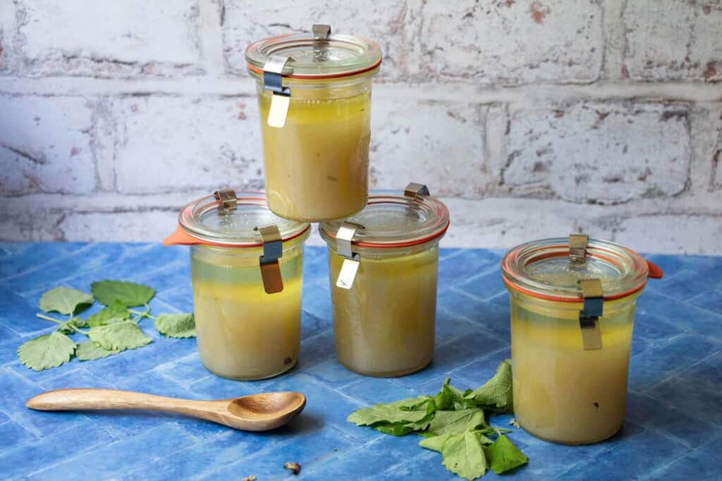 4 small weck jars of pale yellow sugar scrub with lemon balm