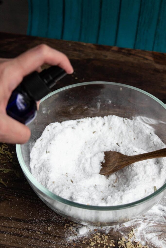 spritzing shower steamer mixture with witch hazel spray bottle