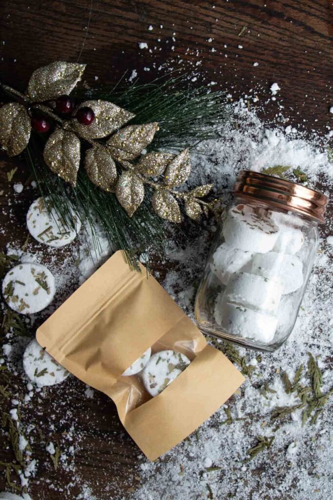 shower steamers displayed as holiday gifts in a mason jar and kraft bags