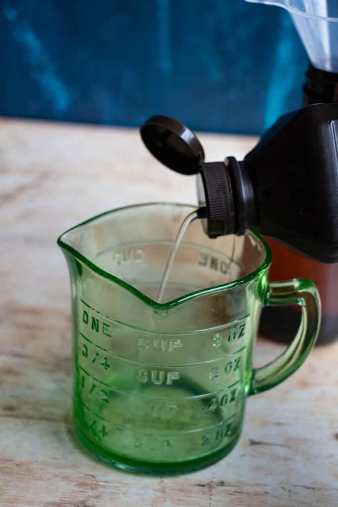 pouring peroxide into measuring cup