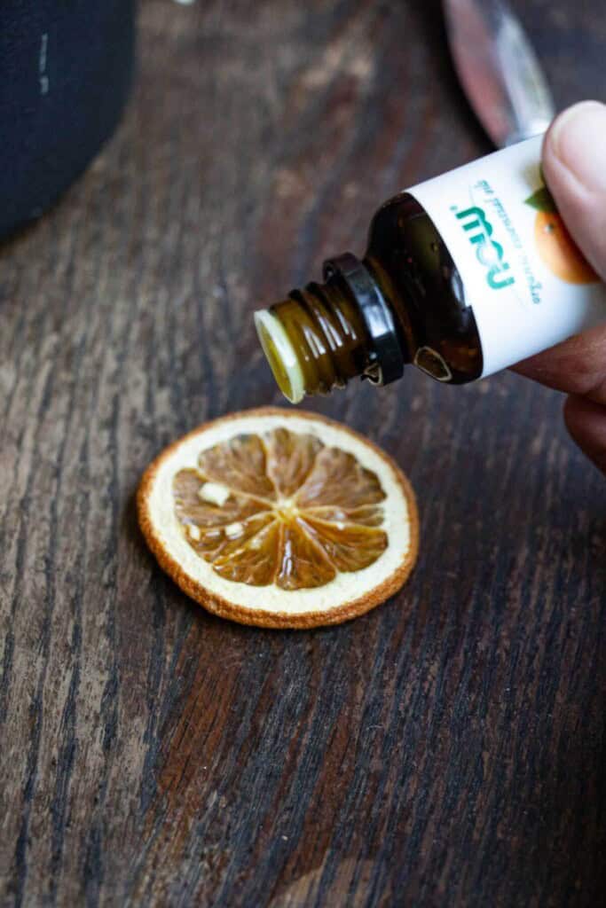 adding essential oils to oranges