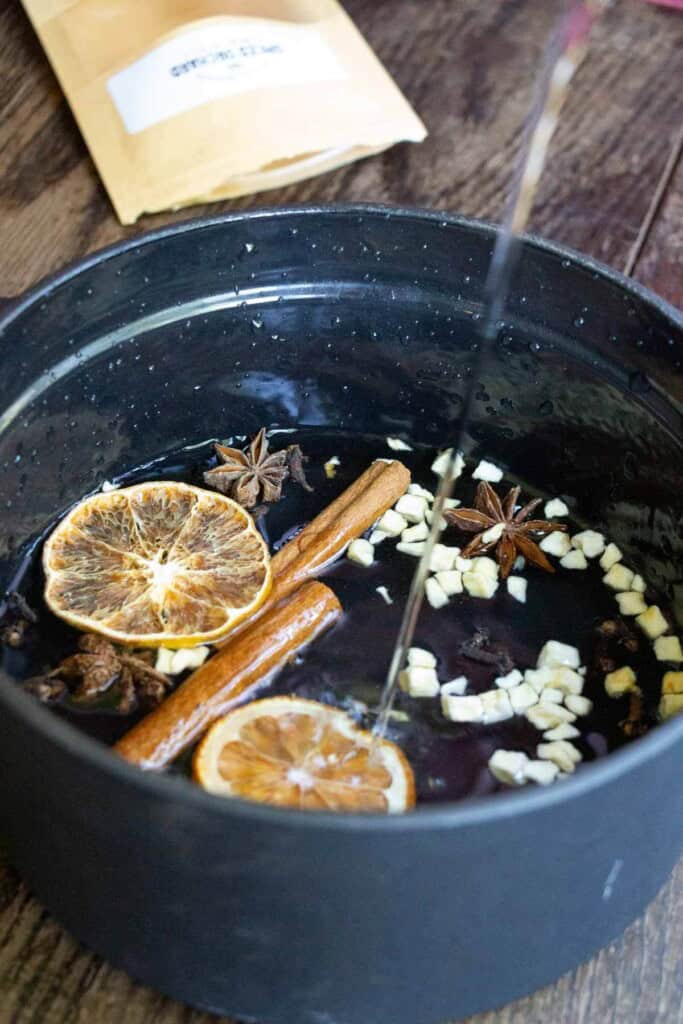 adding water to simmer pot